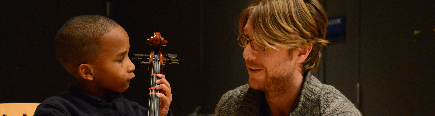 Teacher and student playing cello